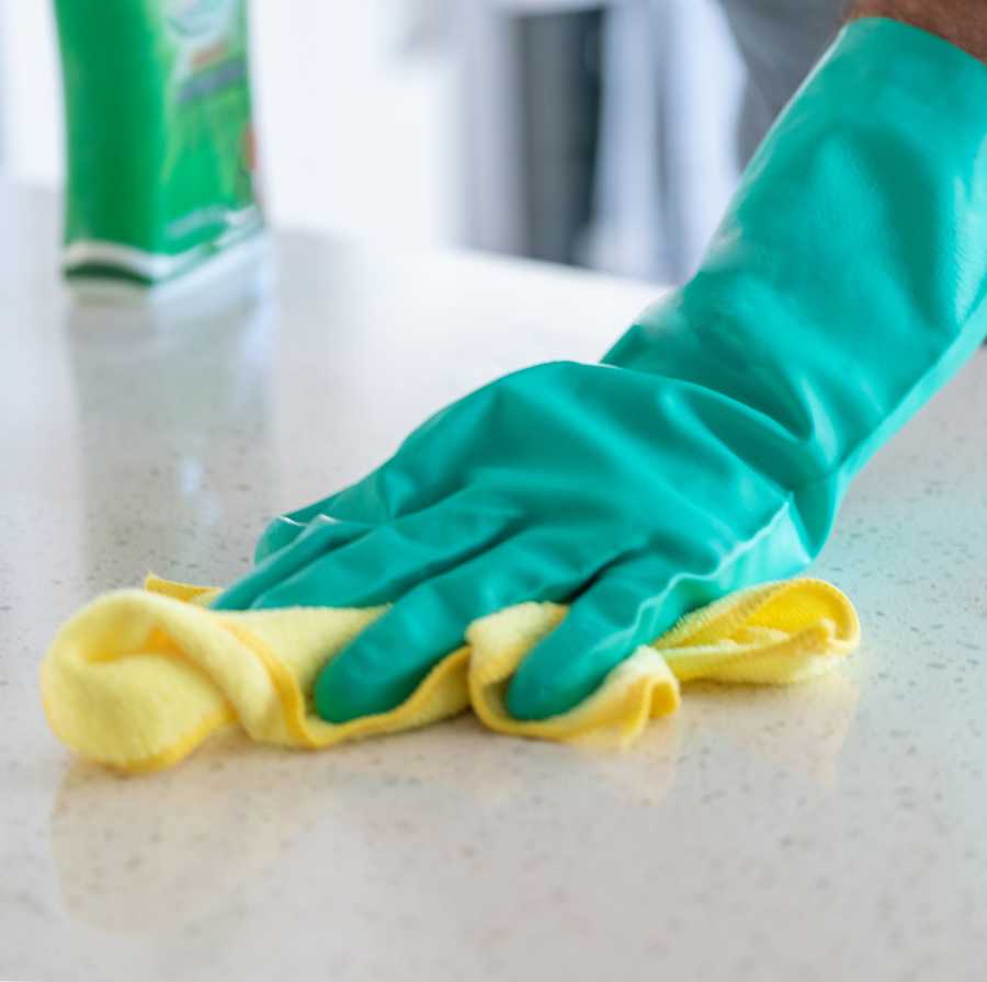 a hand wiping table surfaces