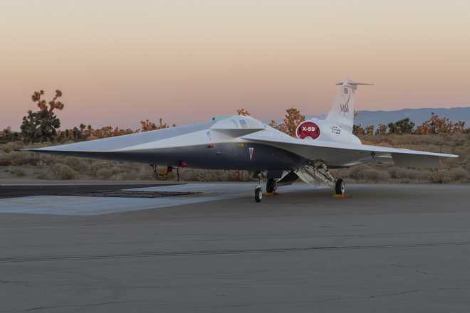 x59 aircraft on ramp with sunset in the background