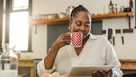 African American woman using a tablet over breakfast at home