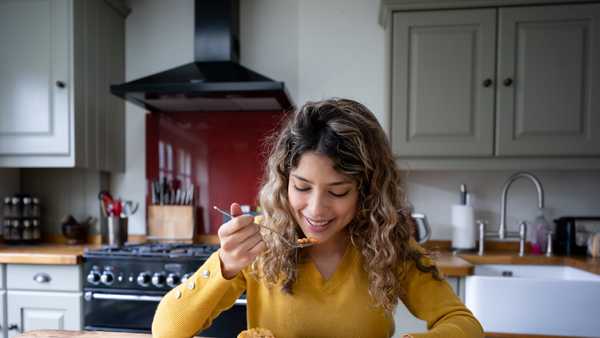 beautiful young woman at home enjoying a delicious english breakfast