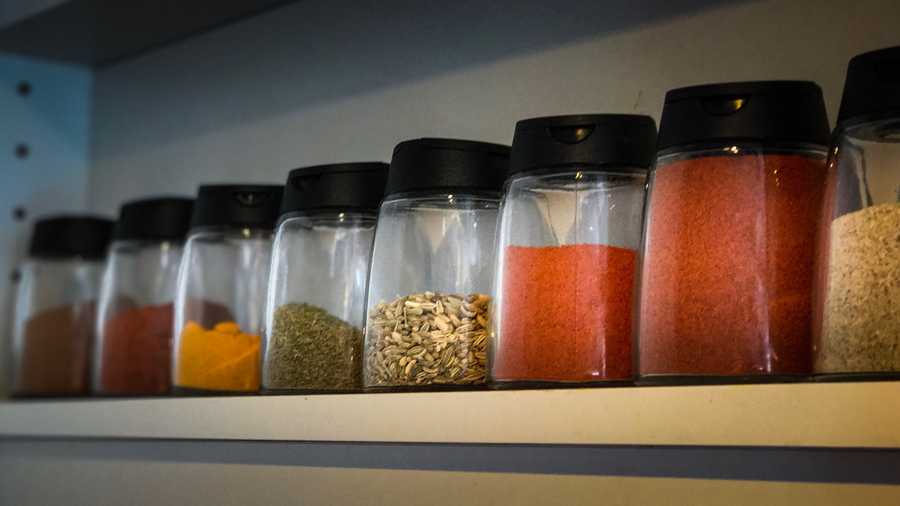 Close-Up Of Shelf With Jars Of Spices