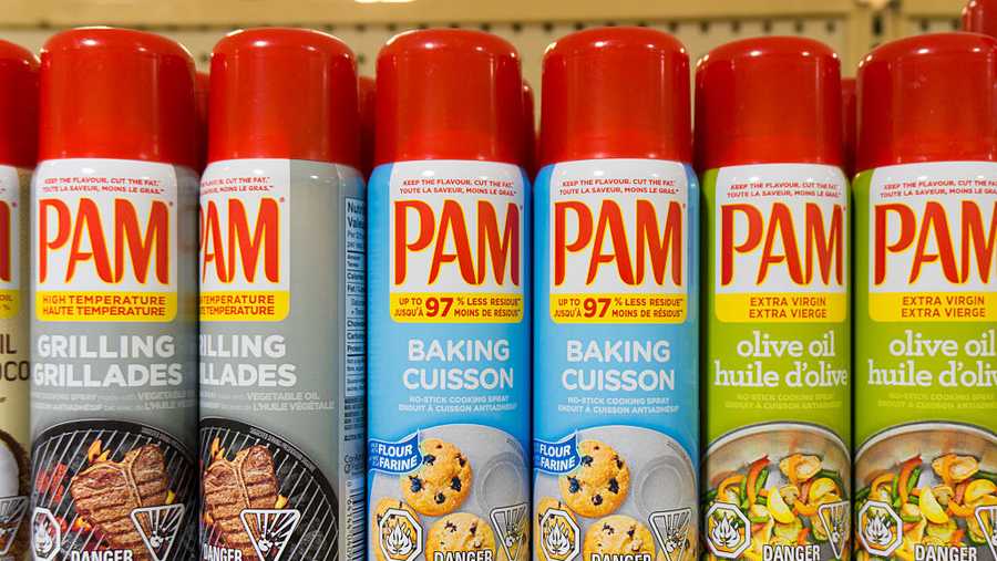 PAM: cooking sprays in store shelf. PAM is a brand name by...