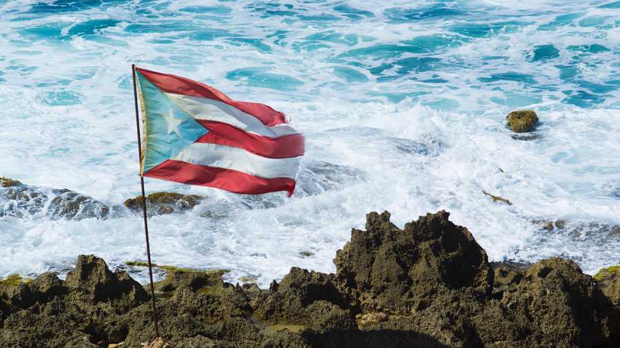 puerto rico flag on rocks near sea