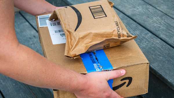 amazon delivery worker places prime packages on doorstep