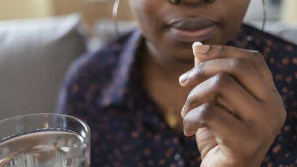 woman taking pill