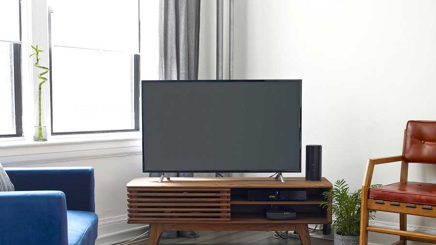 slatted media console with tv in living room