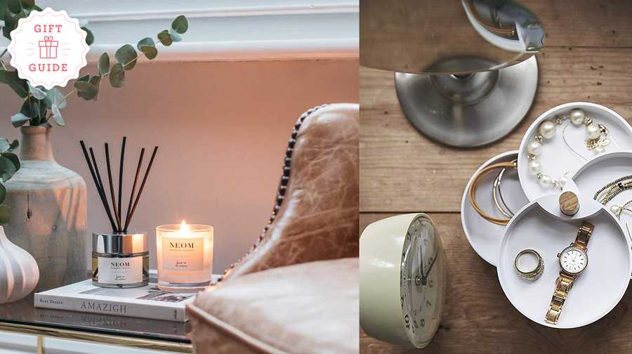mothers day gift ideas including a candle from neom lit on a table and a jewelry dish filled with jewelery