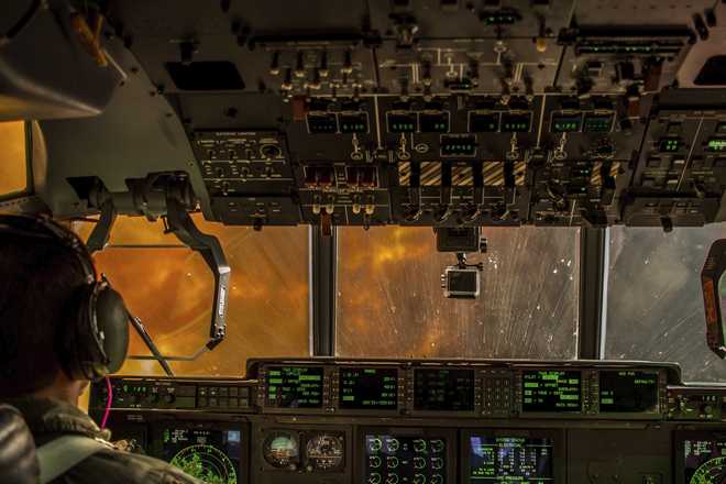 a view from the cockpit of a plane flying into a forest fire