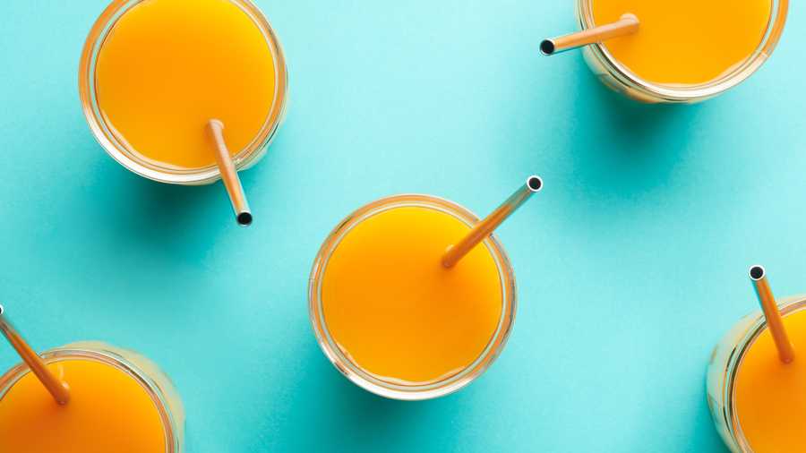 reusable metal straw in orange juice glasses