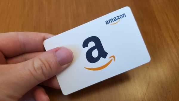 where to buy amazon gift cards, person holding a white amazon gift card