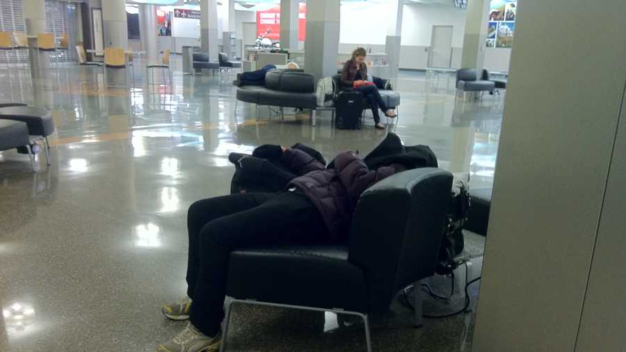 Passengers snuggle in for the night at the Des Moines airport.