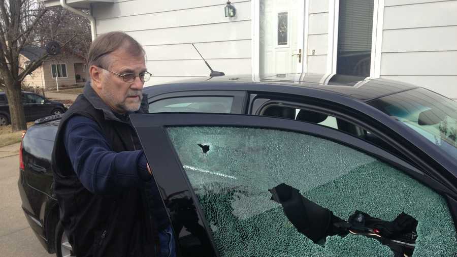 Larry Chiles shows KCCI his car with window shot out.