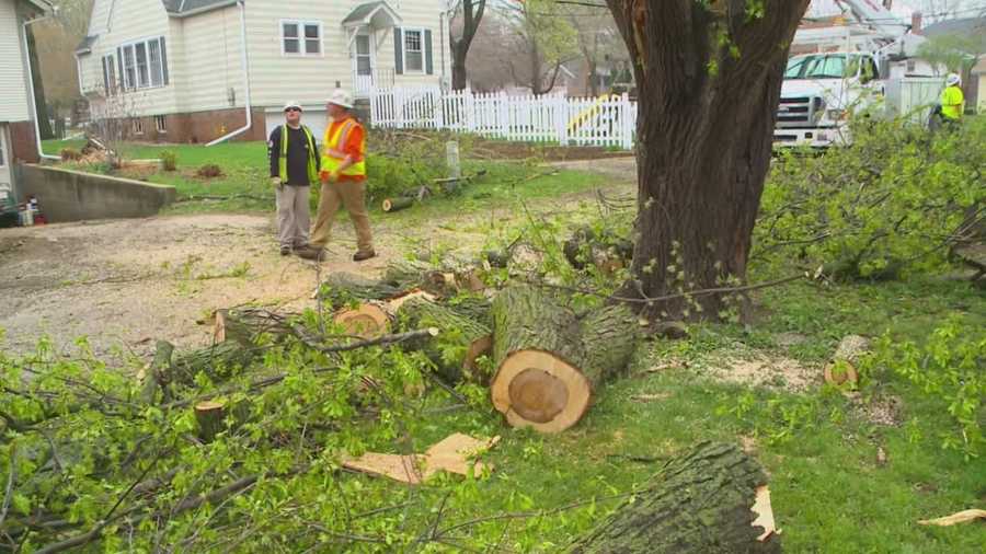 Crews work to restore power and cut down damaged trees after storms hit Iowa Sunday.