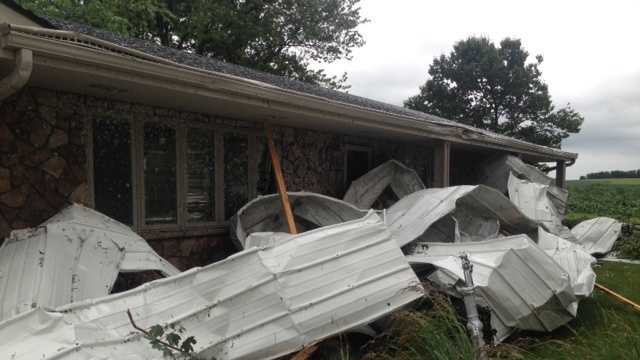 Roof torn off building slams into family's home.