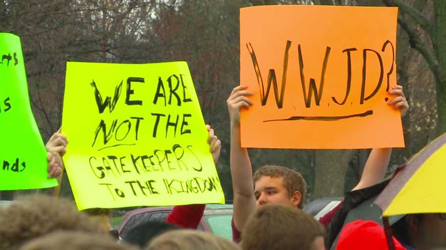 Students and alumni staged a walkout Wednesday in protest of a West Des Moines Catholic high school opting to not hire a substitute teacher full-time after learning he was gay.