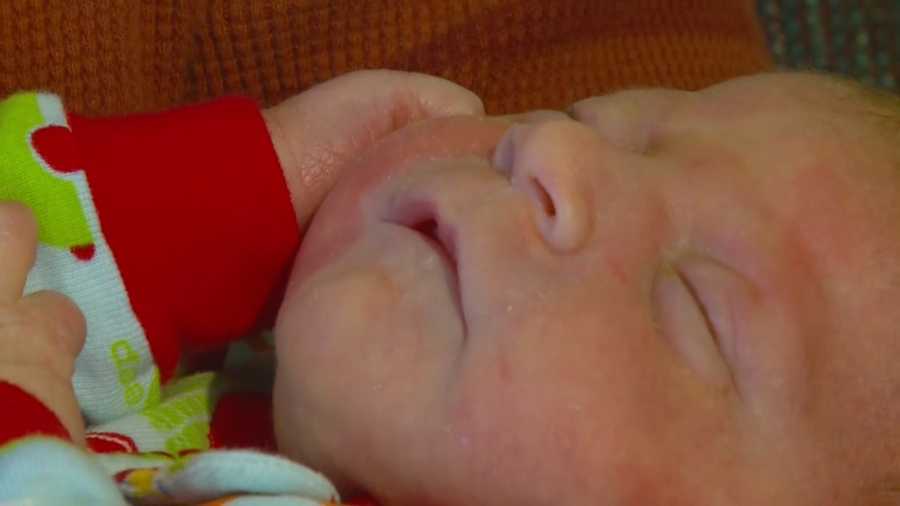 An Iowa police officer helped a new mother give birth in a minivan in a parking lot  .