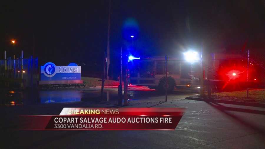 Firefighters battle an early-morning fire at an auto auction.