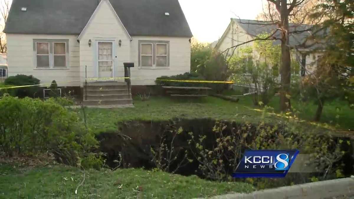 PHOTOS Deep sinkhole develops in Iowan's front yard