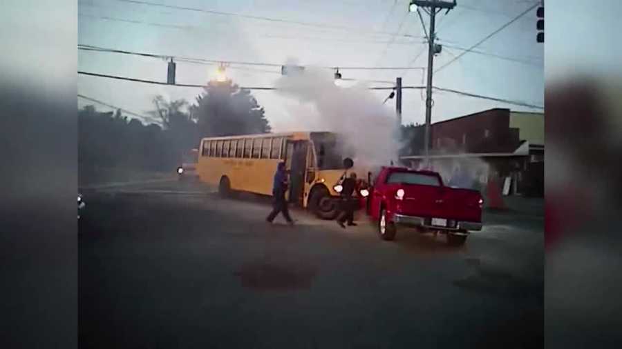 A driver trapped inside a burning truck under a bus was rescued by bystanders and fire crews in Winston-Salem, N.C.