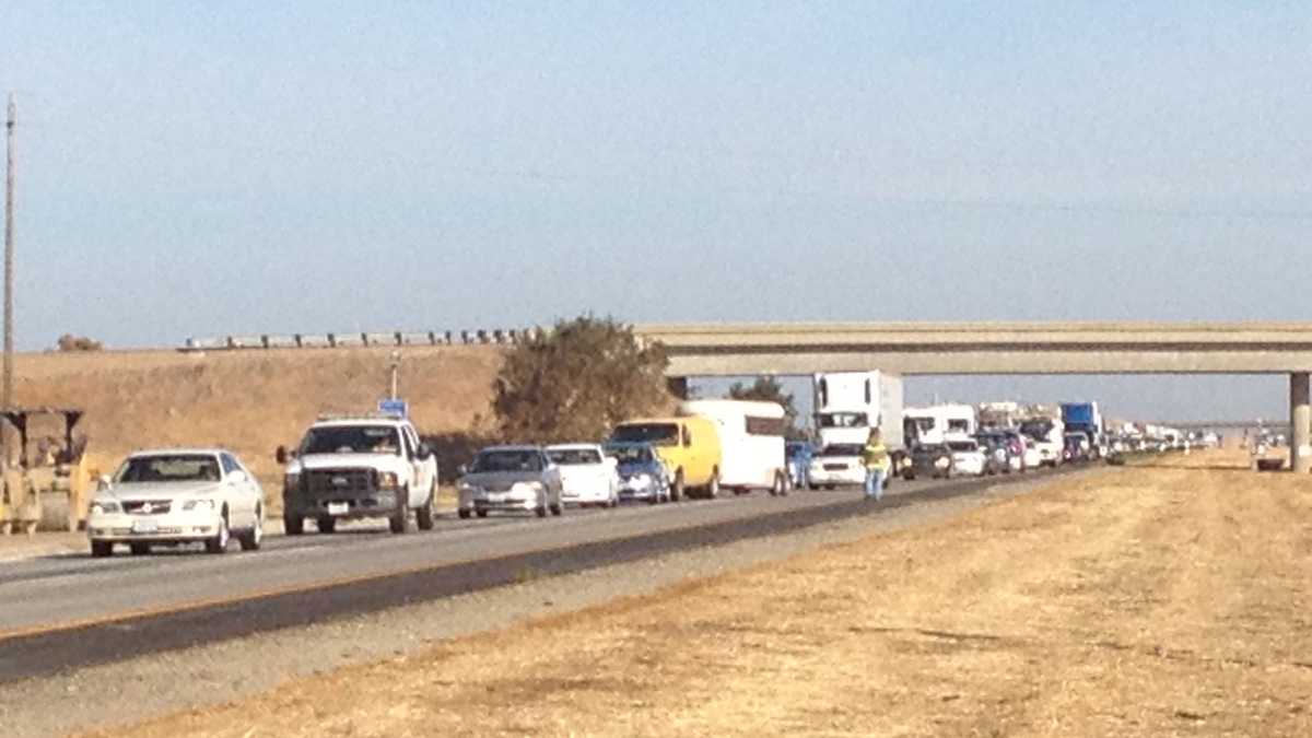 Photos: Overturned big rig leaves hay on I-5, affecting traffic