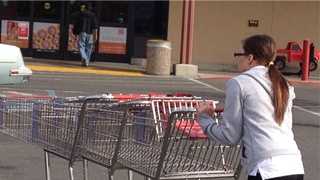 A Raley's employee in West Sacramento wheels carts back toward the store.