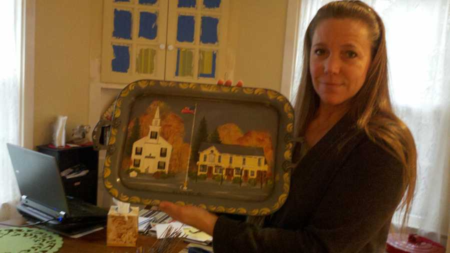 Wendy Aurelia of Stockton holds a tray painted with scenes from her hometown of Newtown, Conn.