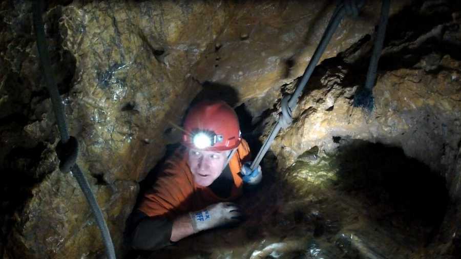 KCRA 3 photographer Mike Rhinehart feels the squeeze as he wiggles his way through one of the many challenges in Moaning Cavern.