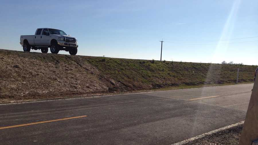 A truck sits atop the newly raised levee along the Garden Highway north of Sacramento.