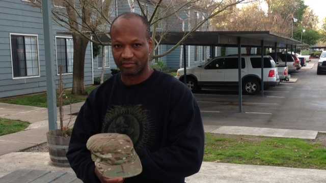 Sgt. Cecil Edwards shows a cap, one of the few items thieves left behind (March 8, 2013).