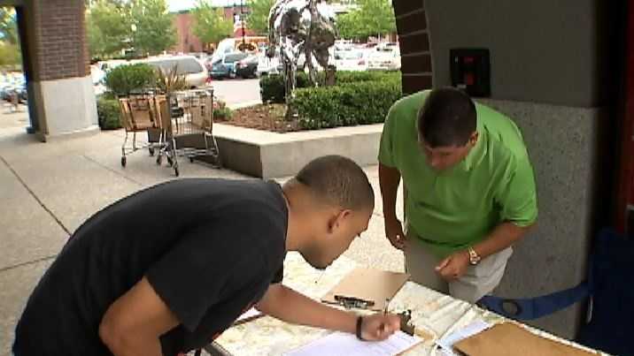 Arena subsidy opponents collect petition signatures on June 26 in Sacramento.