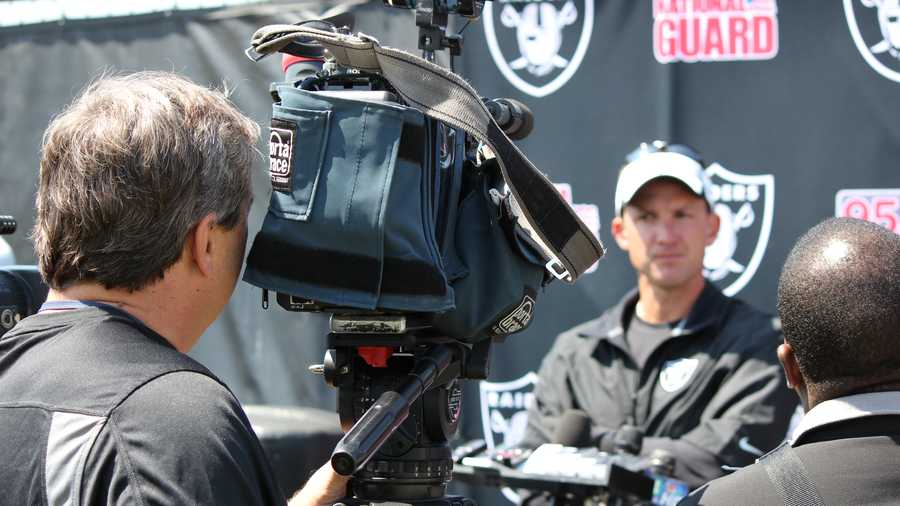 Then-head coach Dennis Allen speaks to the media at 2013 training camp.
