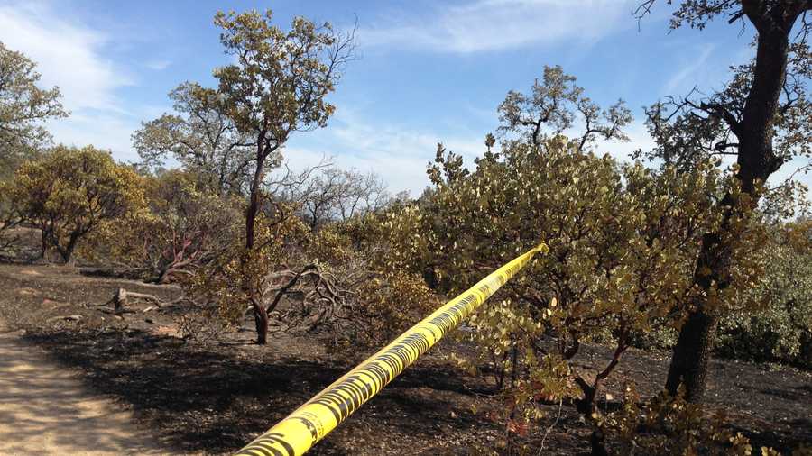Crime tape marks the spot where a man's burned body was discovered in Shasta County.