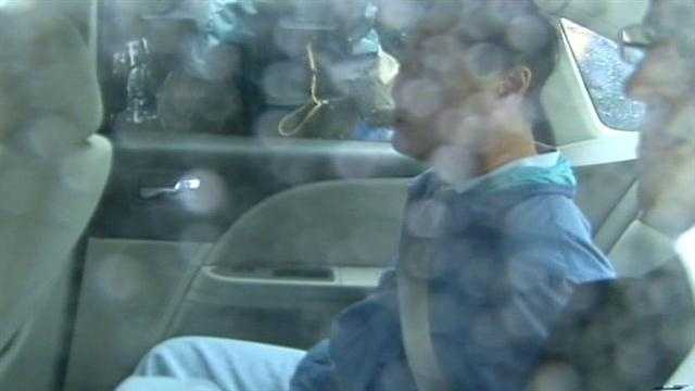 Yee is seen inside the vehicle with his hands behind his back.
