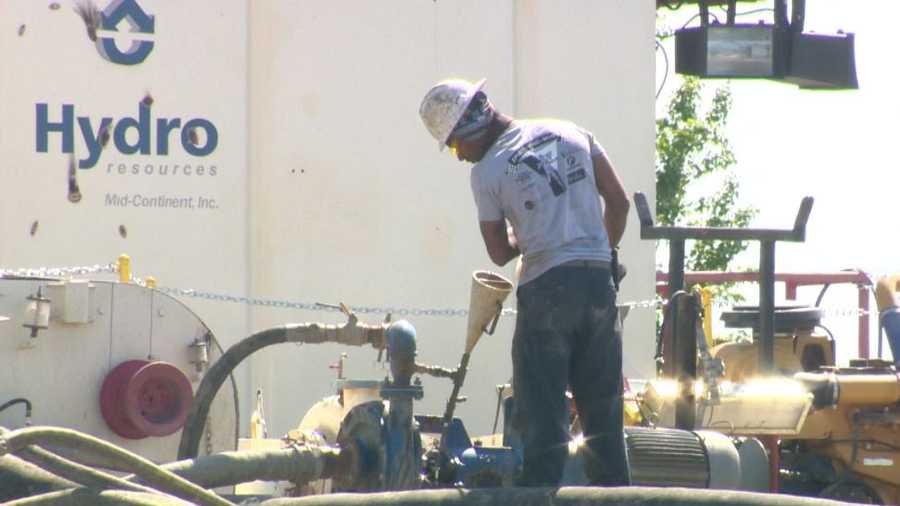 A worker helps drill a new water well for the city of Sacramento.