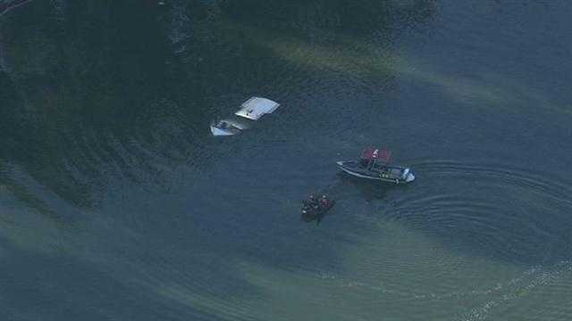 Rescue crews located a sinking boat underneath the I Street Bridge Wednesday morning.