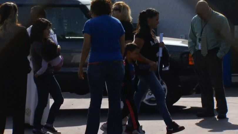 Women and children arrive at a church in San Bernardino County on Thursday.