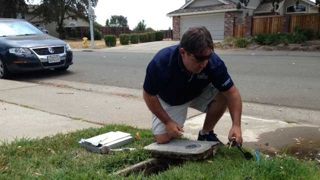Roseville water specialist John Shannon inspects a leak.