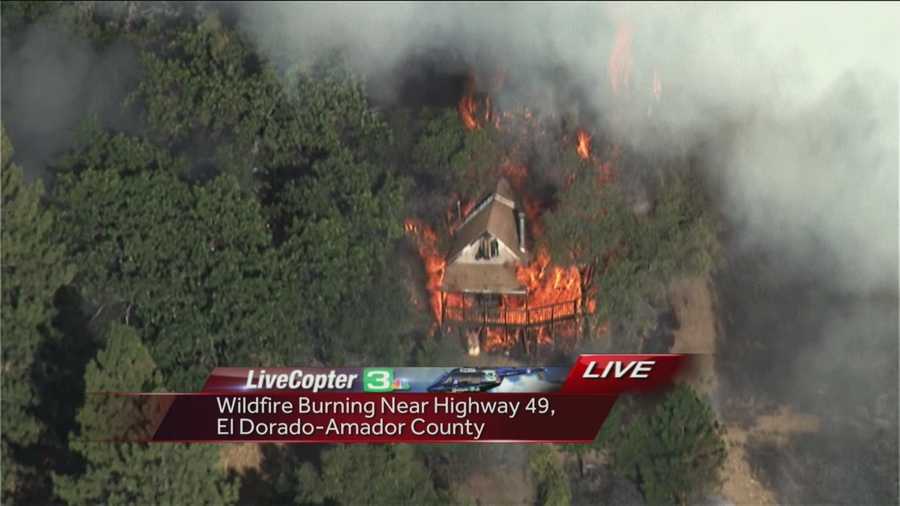 A grass fire in El Dorado and Amador counties burns a home off Highway 49.