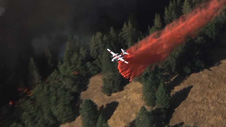A grass fire burning along the line that separates Amador and El Dorado counties continues to grow Friday night, and is forcing evacuations for people who live along Sand Ridge Road and Freshwater Lane.