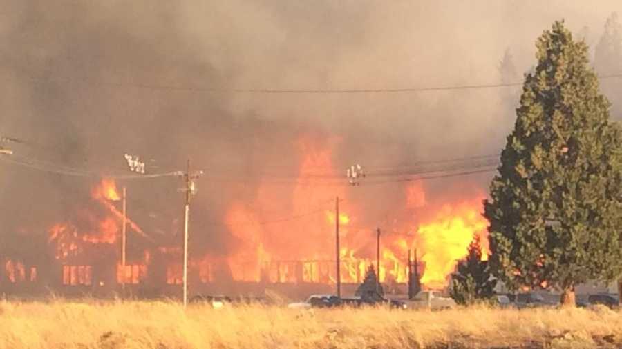 Firefighters are gaining ground on a wildfire Tuesday that raced through the far Northern California town of Weed, which damaged or destroyed 100 homes and a church.