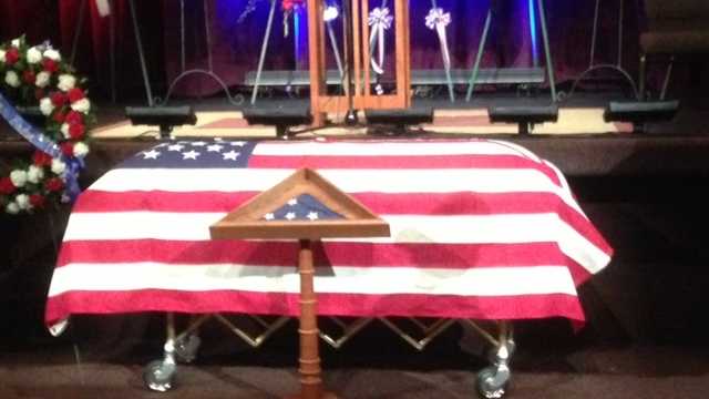 The U.S. Honor Flag sits in a display case in front of Sacramento County Sheriff's deputy Danny Oliver's casket.
