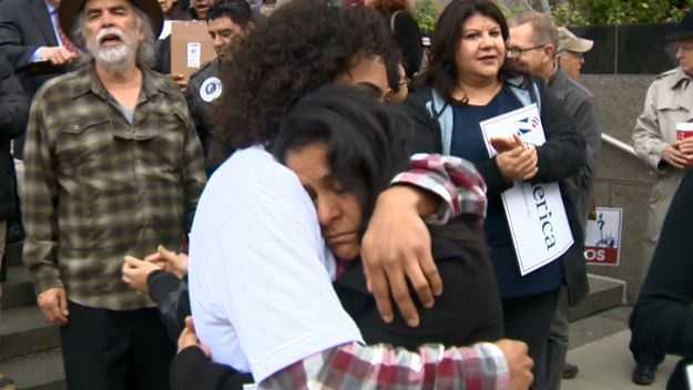 Monica Garcia and her son Jonathan Guerrero hug one another outside the federal courthouse in Sacramento.