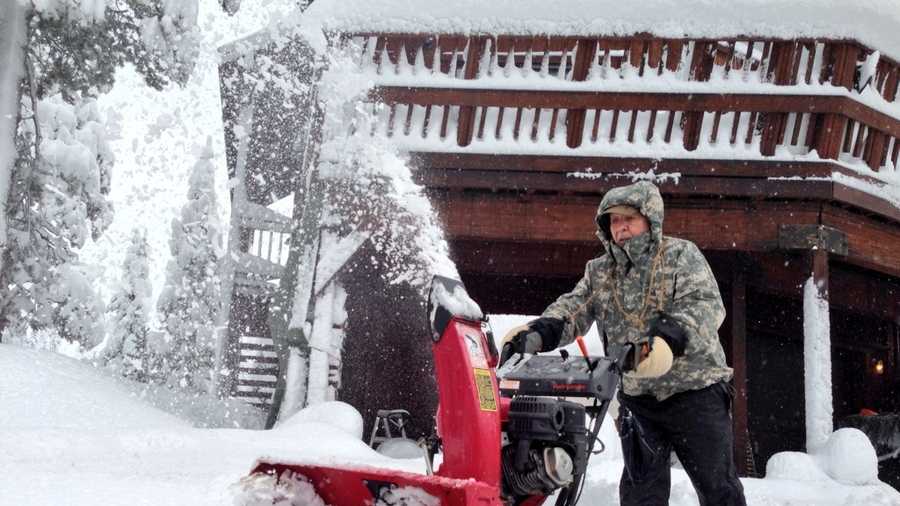 Bob Norgard of Serene Lake's clears his drive after two feet of snow fell Thursday and Friday.