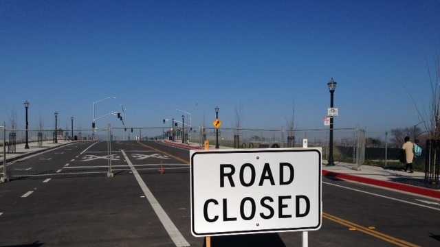 The city of Sacramento says it does not know when it will remove the road-closed signs from the recently completed streets into the downtown railyards development project.