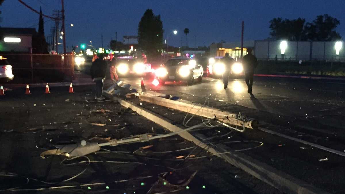 Busy road reopens after vehicle slams into power pole