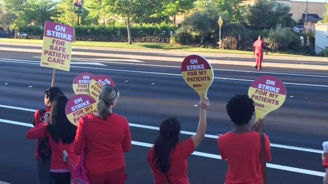 Nurses on strike hold up signs along East Roseville Parkway near Sunrise Boulevard on Thursday morning.