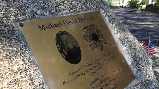 Neighbors on Riverview Drive in Auburn dedicated a memorial to Detective Mike Davis who was shot and killed on their street during a manhunt last October.