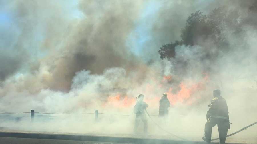 Sacramento Metro Fire crews battle a grass fire in South Sacramento on Thursday. (June 18, 2015)