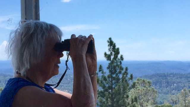 Volunteer lookout Judy Ten Ecyk keeps watch from a fire tower near Grass Valley.