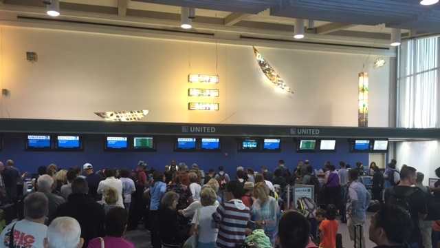 People are waiting in long lines at the United Airlines counter at Sacramento International Airport. (July 8, 2015)